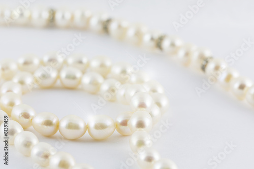 Beautiful creamy pearls necklace curve isolated on white backgro