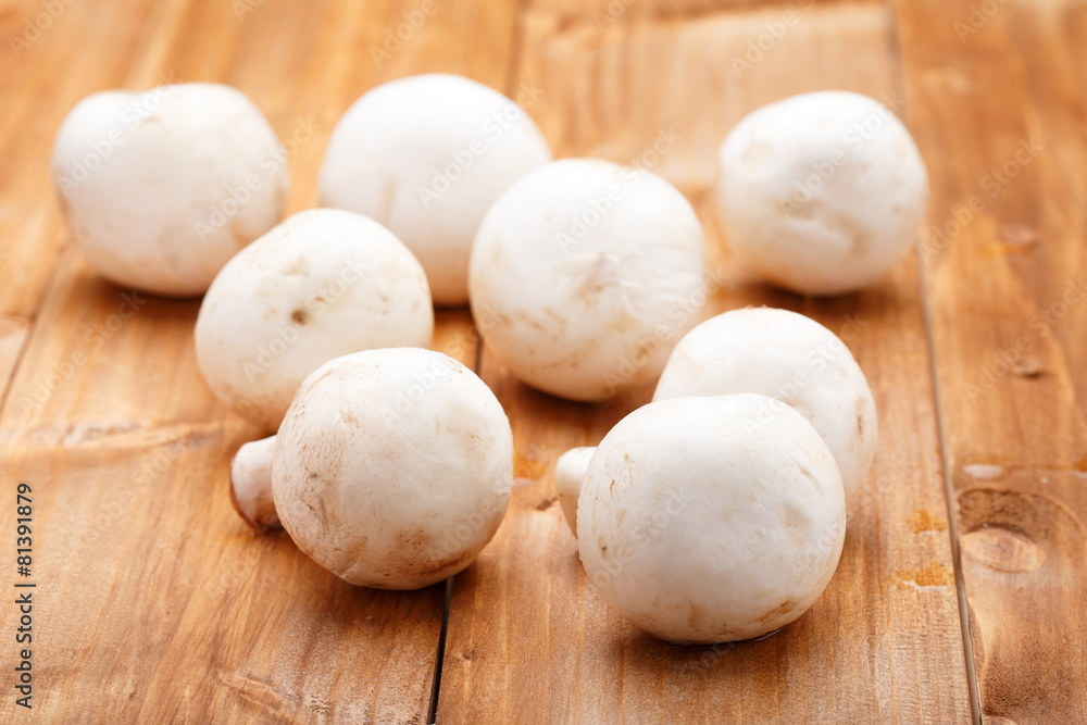 champignons closeup on wooden background champignons closeup on wooden background