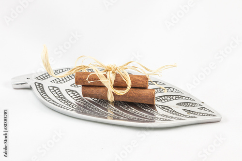 three pieces of cinnamon on a sheet of silver tree