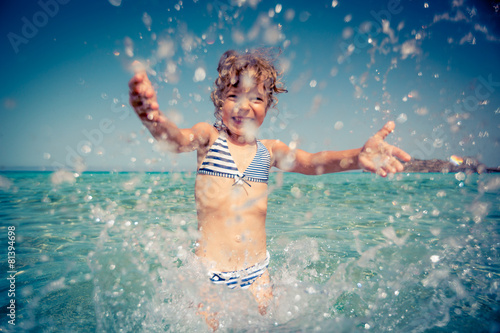 Happy child playing in the sea