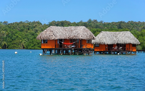 Overwater bungalow with thatched roof