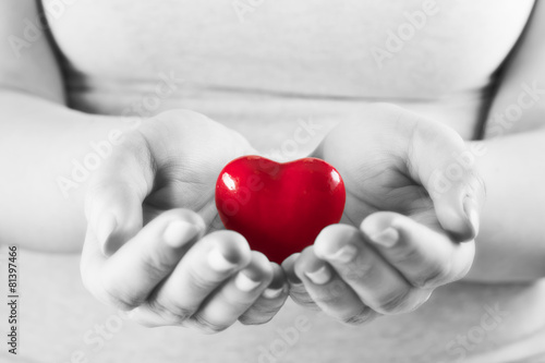 Heart in woman hands. Love giving  care  health  protection.