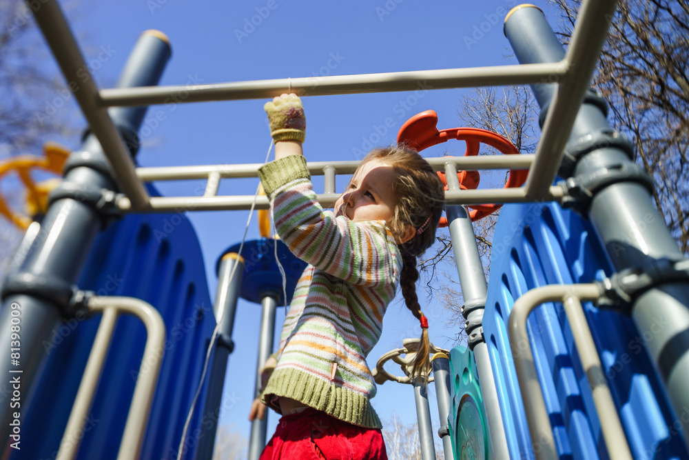 Cute little girl playing on child playground