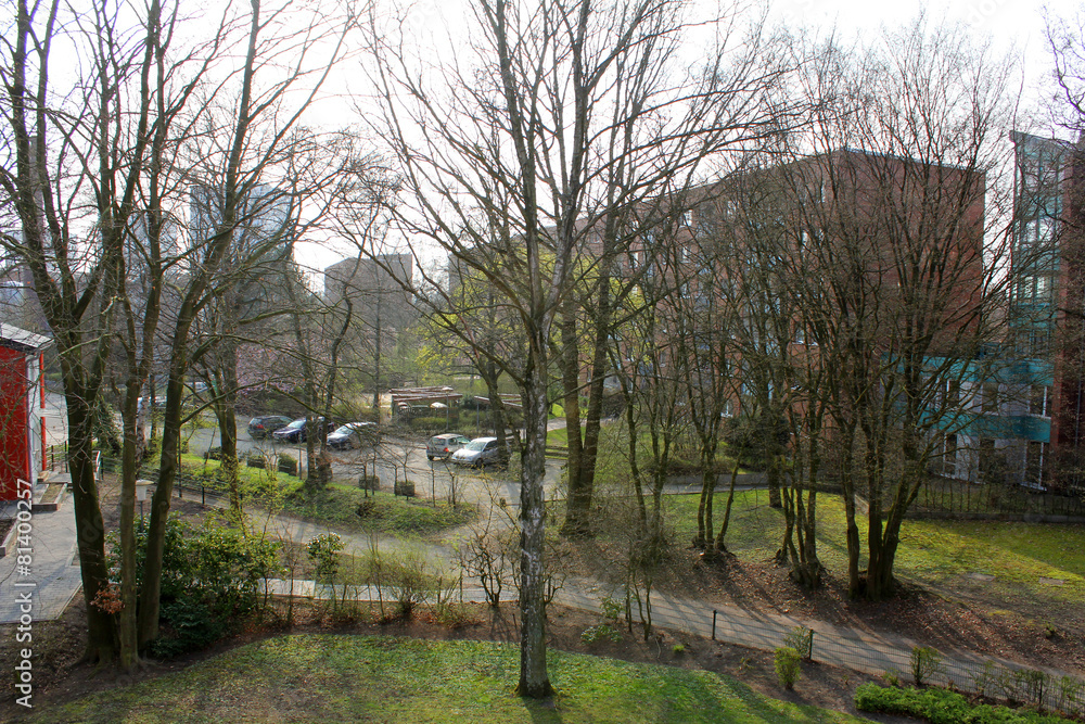 The multi-storey building behind trees The multi-storey building behind trees