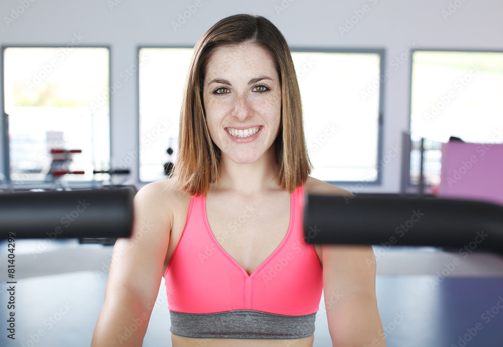 Young woman uses stationary bicycle trainer. Young woman uses stationary bicycle trainer.