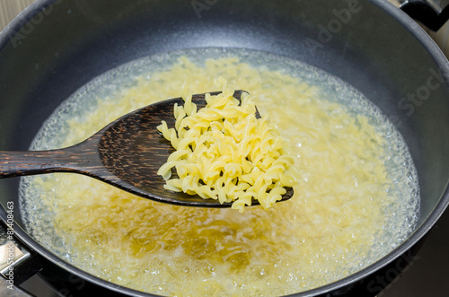 Boil macaroni in a pot