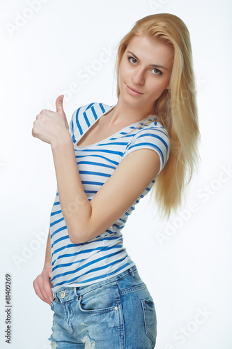 Happy young denim girl showing thumb up sign isolated on white b