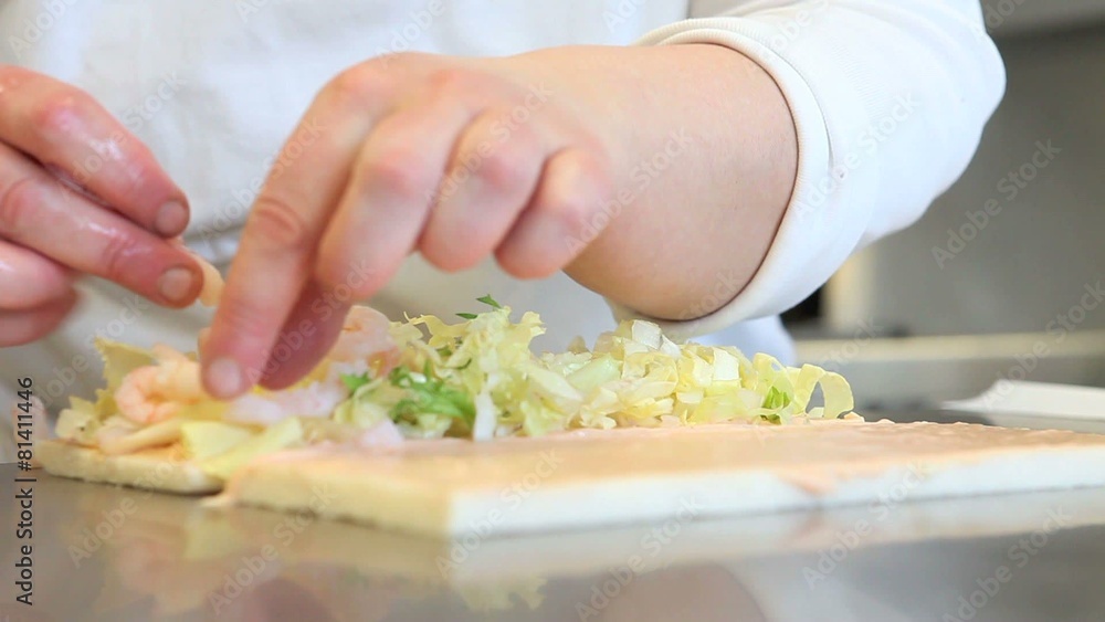 Hands prepare a sandwich with shrimp and lettuce Hands prepare a sandwich with shrimp and lettuce