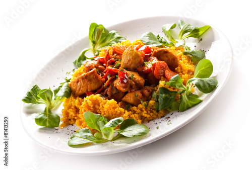 Roasted meat with pearl barley and vegetables on white backgroun