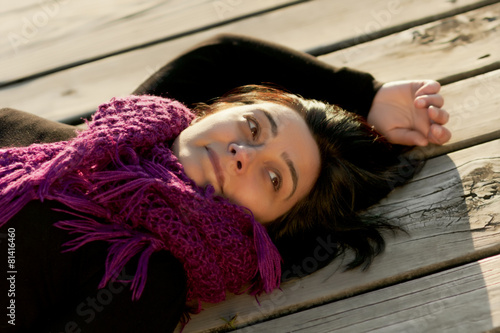 woman resting on wooden footpath close up