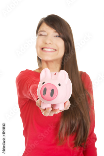 Happy young woman with piggybank.