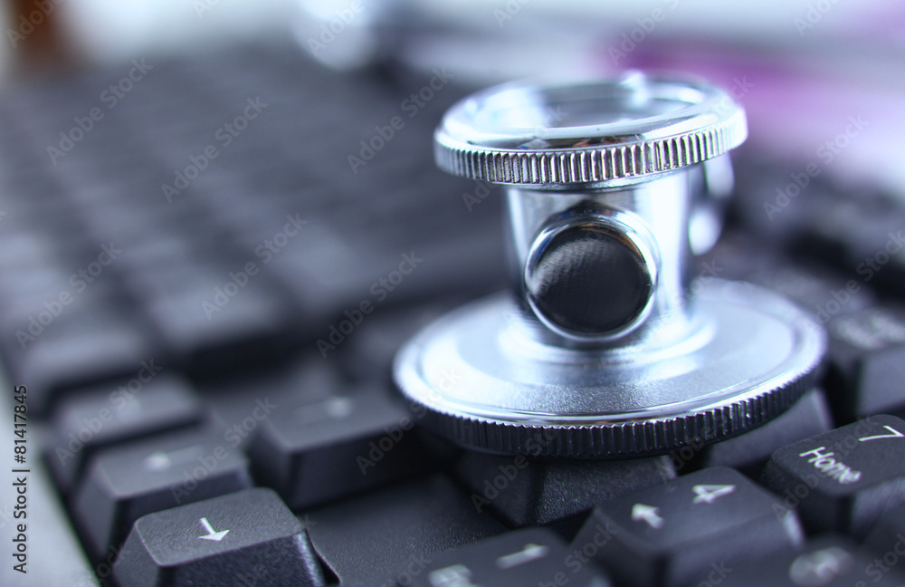 Violet stethoscope on a laptop computer Violet stethoscope on a laptop computer