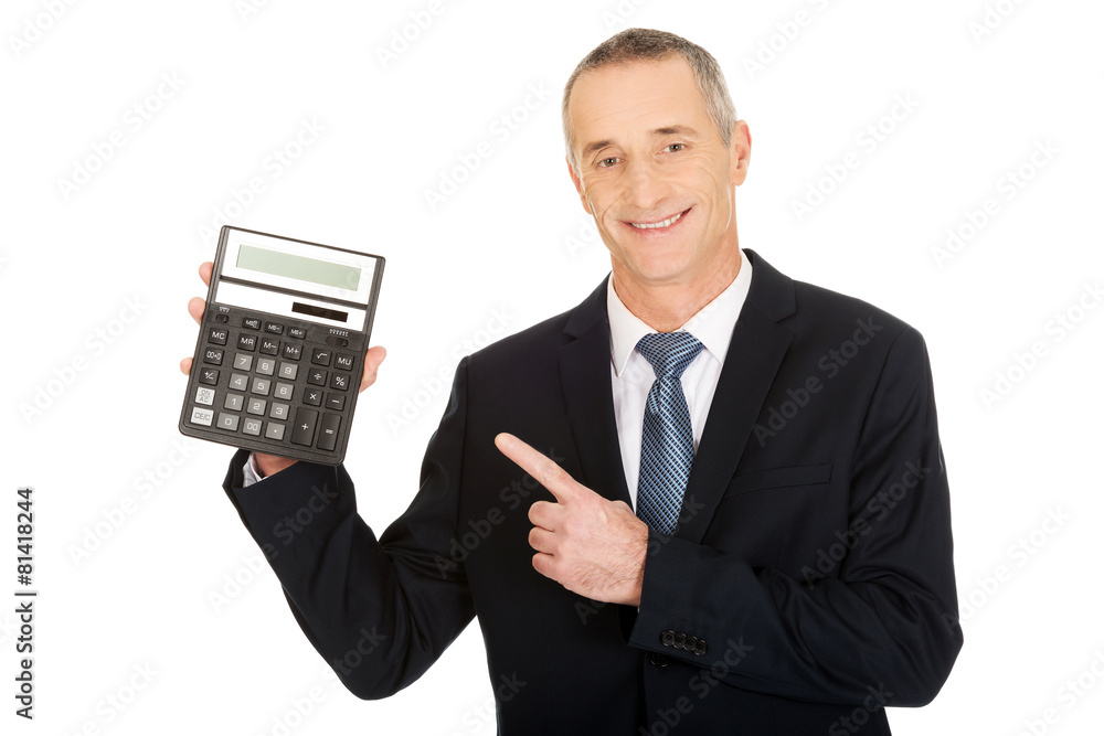 Happy businessman pointing on calculator Happy businessman pointing on calculator
