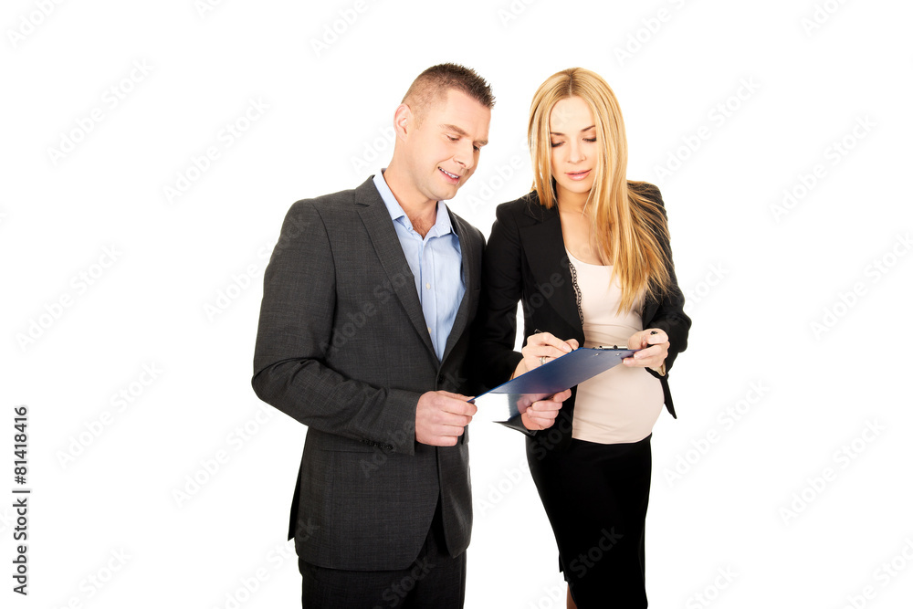 Pregnant businesswoman signing a contract Pregnant businesswoman signing a contract