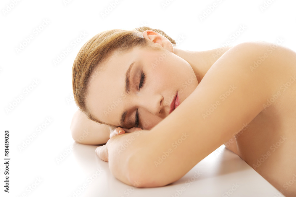 Beautiful spa woman resting her head on desk. Beautiful spa woman resting her head on desk.
