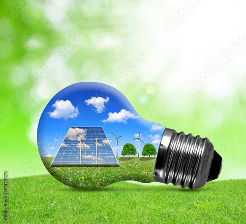 Solar panels and wind turbines in light bulb. Green energy.