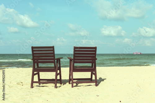 two wooden chairs on the beach, bright vintage filter wallpaper © OPgrapher