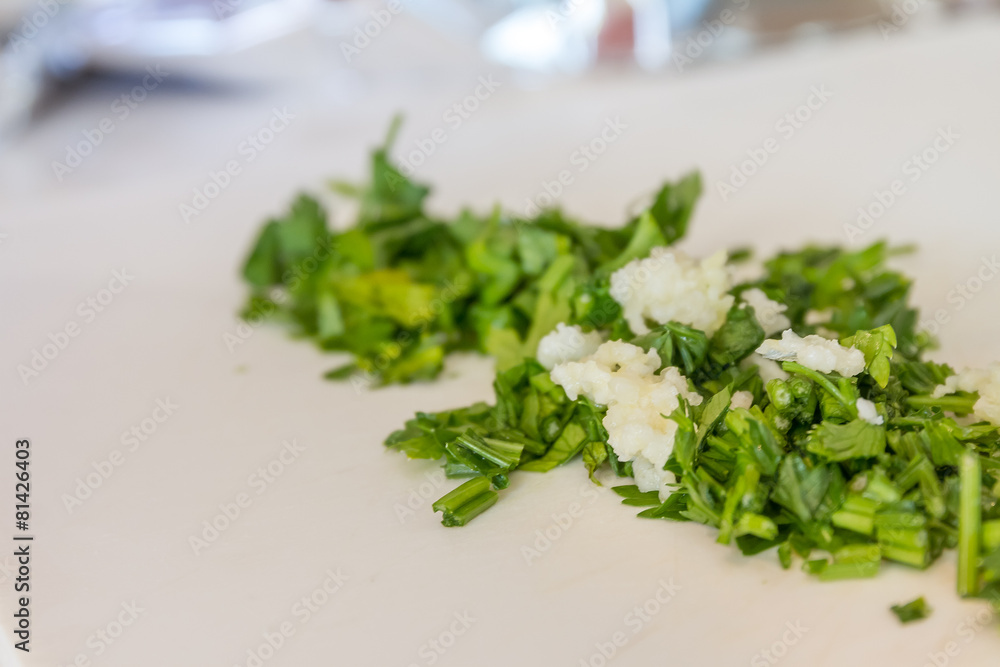 parsley and garlic on wooden cutting board, cooking time backgro parsley and garlic on wooden cutting board, cooking time backgro