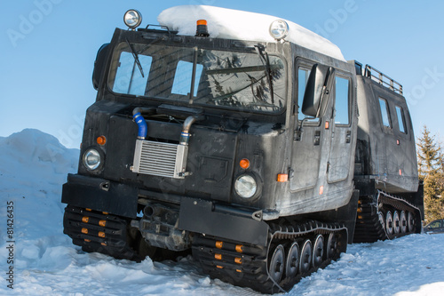 articulated military tracked cargo vehicle on snow
