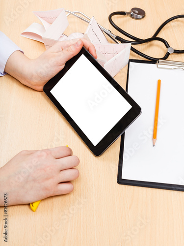 doctor looks on tablet pc with cut out screen