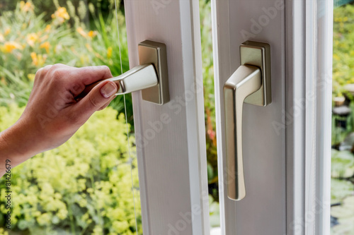 Frau öffnet Fenster zum Lüften