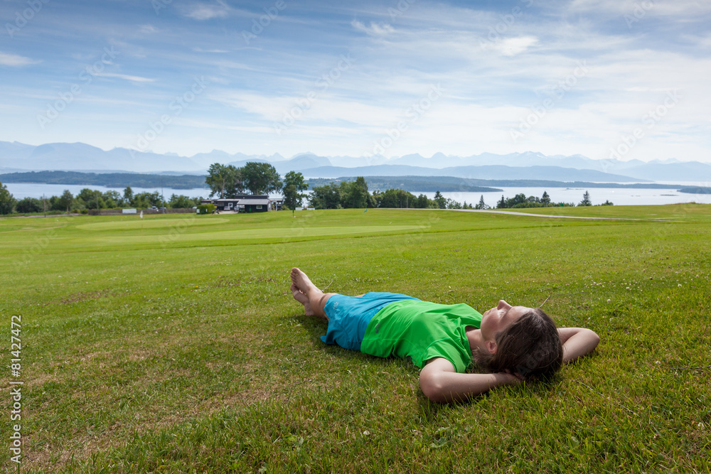 Woman takes rest on green field Norway countryside Woman takes rest on green field Norway countryside