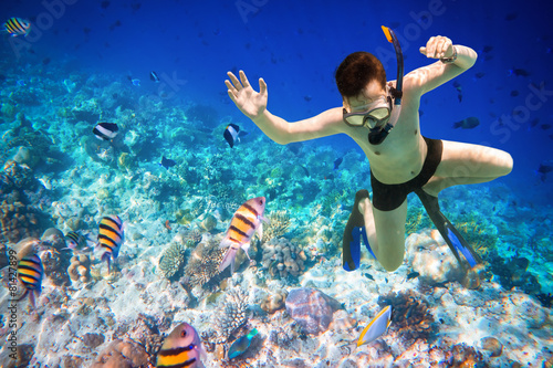 Snorkeler Maldives Indian Ocean coral reef.