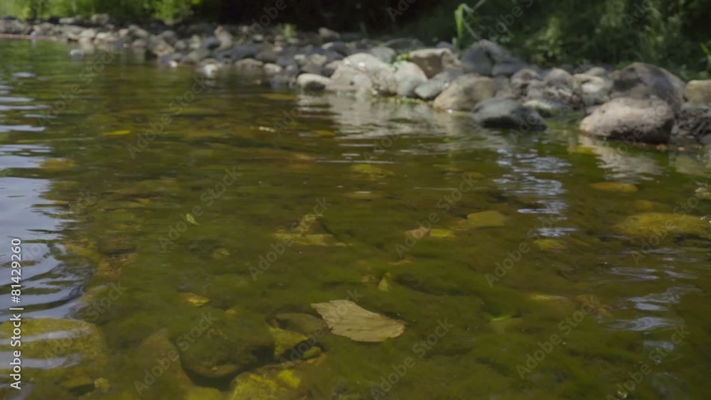 waterfall are flowing through a rock in the shallow water area waterfall are flowing through a rock in the shallow water area
