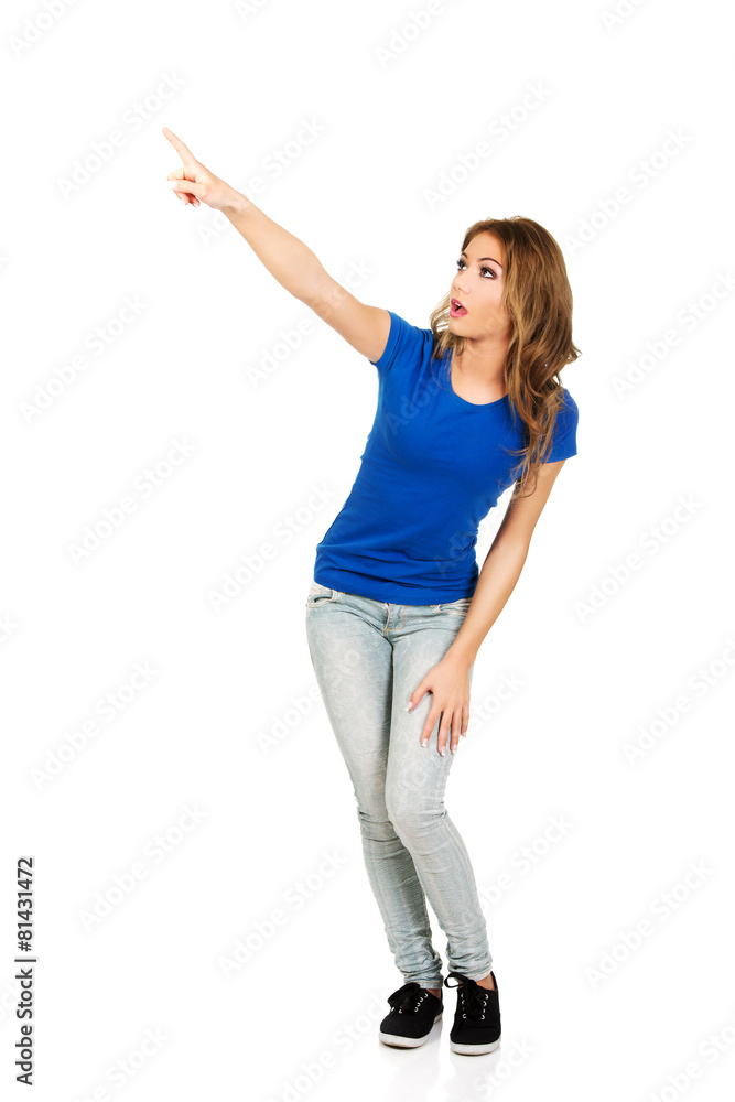 Beautiful young woman pointing up. Beautiful young woman pointing up.