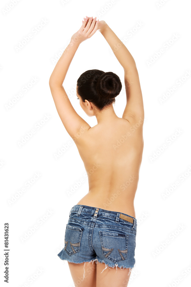 Shirtless woman in jeans shorts. Shirtless woman in jeans shorts.