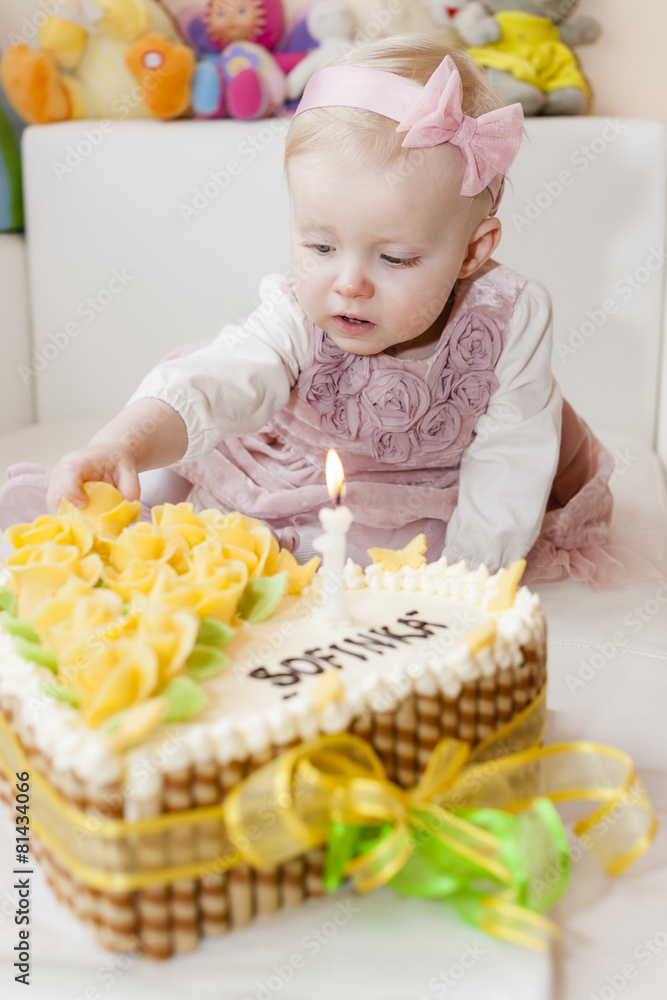 portrait of sitting toddler girl with her birthday cake portrait of sitting toddler girl with her birthday cake