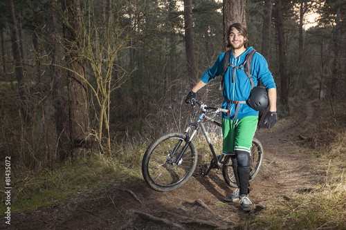 Young man with his ATB in the forest © corepics