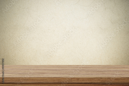 Empty wooden table over cement wall background