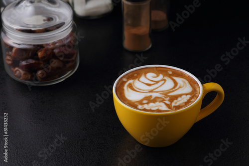 Cup of cappuccino on dark background