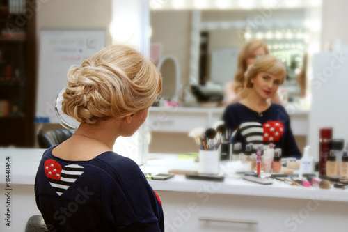 Girl doing her hair in the salon © alexshalamov