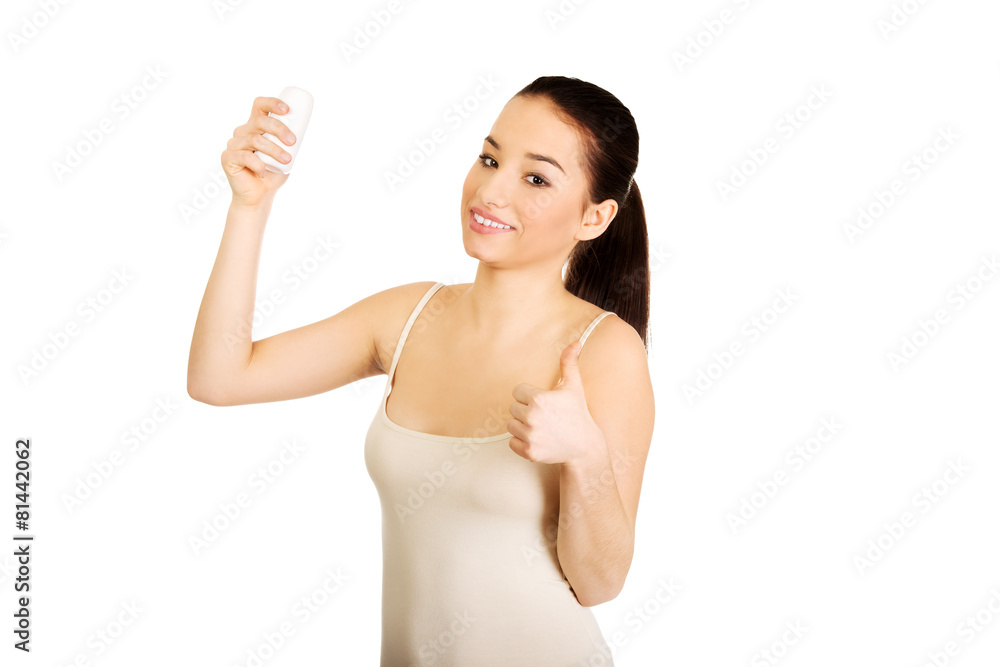 Woman with anti perspirant and thumbs up. Woman with anti perspirant and thumbs up.
