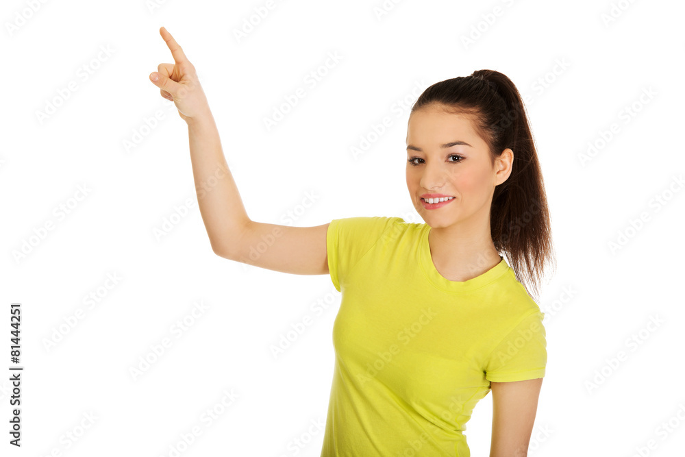 Young woman pointing up. Young woman pointing up.