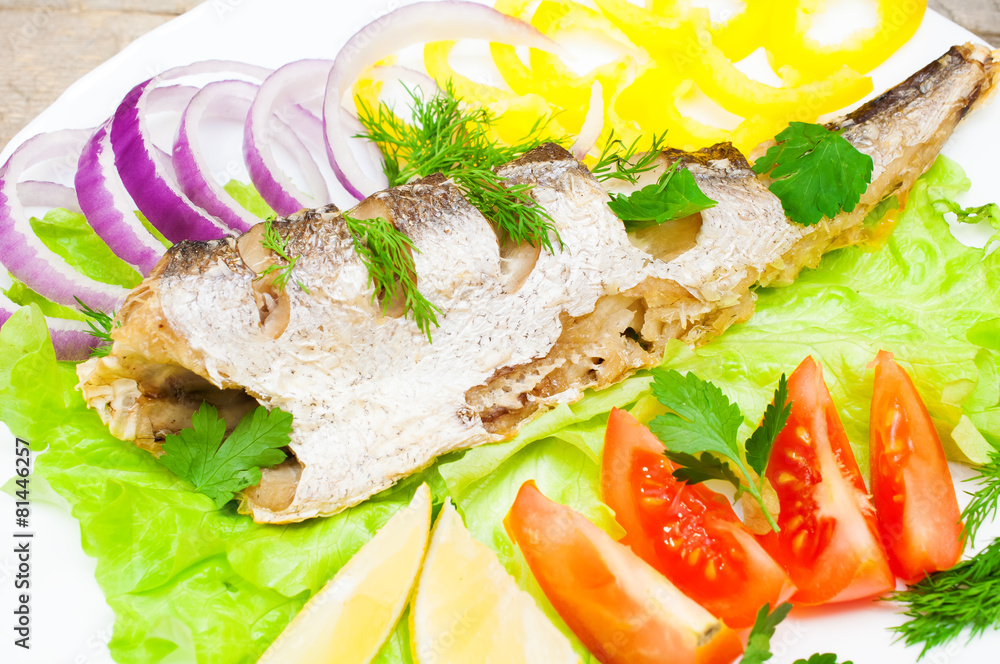 fish hake baked with vegetables on a plate fish hake baked with vegetables on a plate