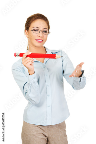 Businesswoman holding big pencil.