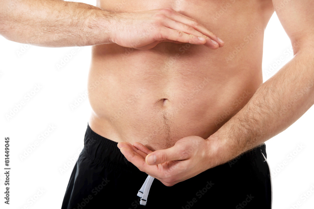 Naklejka premium Sexy muscular man holding copyspace in hands.