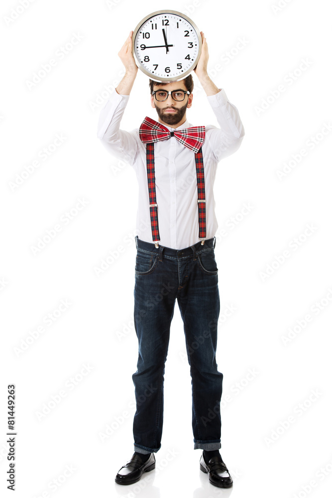 Man wearing suspenders holding big clock. Man wearing suspenders holding big clock.