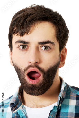 Young shocked man with mouth open.