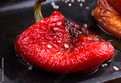 Tasty roasted red and orange bell peppers in pan