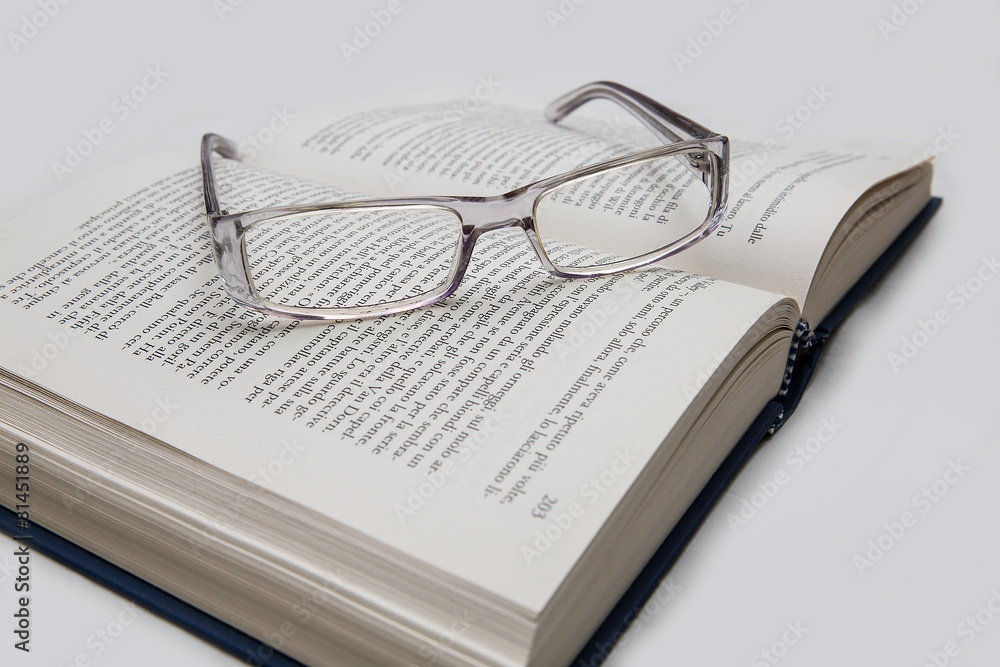 eyeglasses on the page of a book eyeglasses on the page of a book