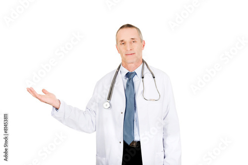Male doctor holding copyspace