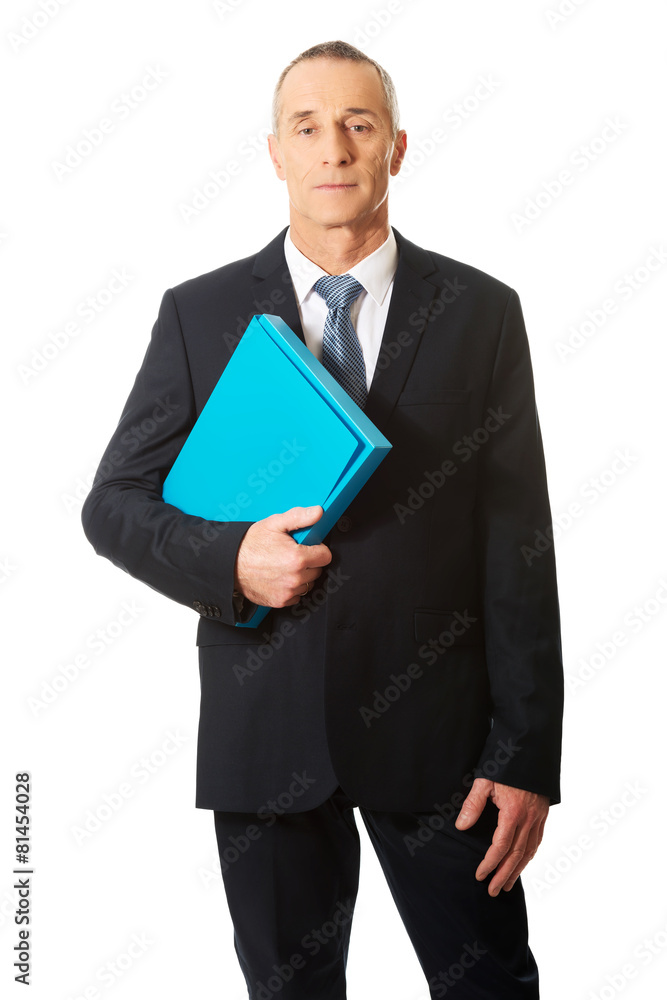 Mature businessman holding a binder Mature businessman holding a binder