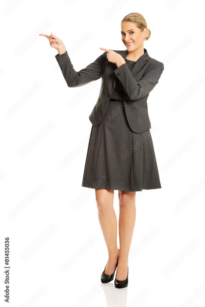 Businesswoman showing copy space on the left Businesswoman showing copy space on the left