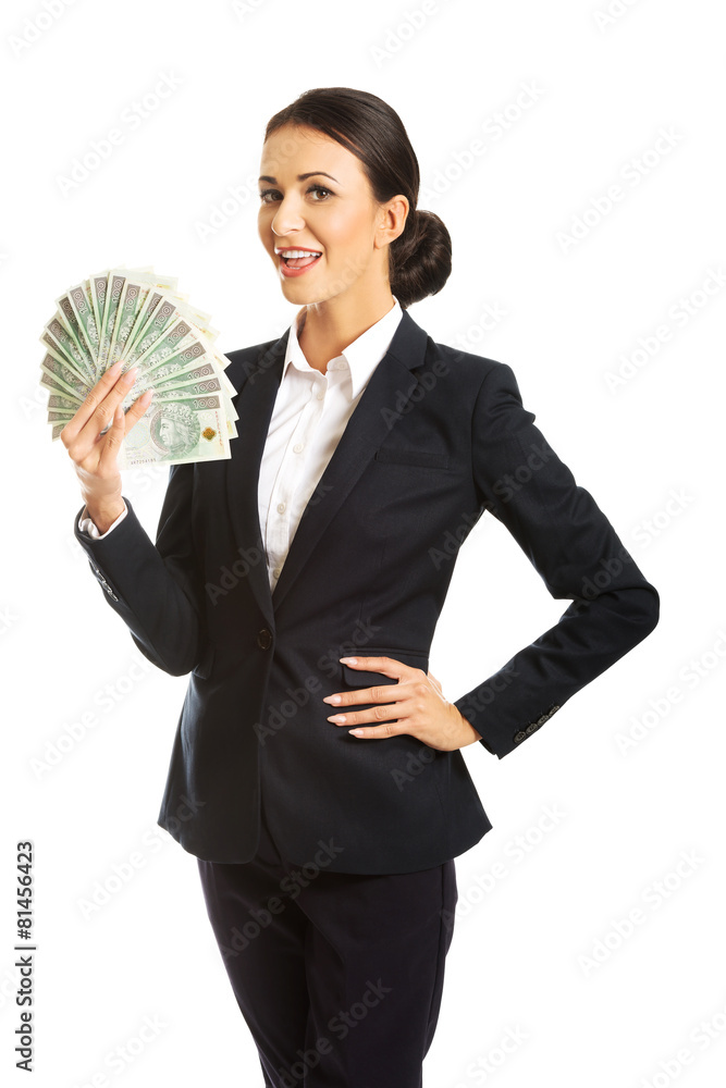 Businesswoman holding a clip of polish money Businesswoman holding a clip of polish money