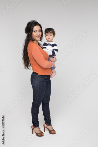 Image of a happy brunette mother with a child on a white
