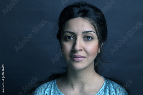 Beautiful trendy girl with fashionable makeup in a studio posing photo